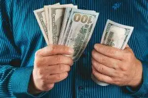 Jobs with exercise science. 4 A man holding salary in hands