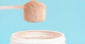 Does protein powder go bad: A scoop of protein powder taken from its tube.